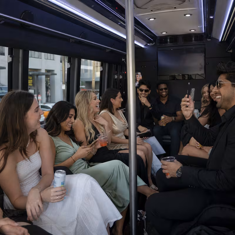 Party bus interior with wraparound leather seating and LED lighting in New Brunswick