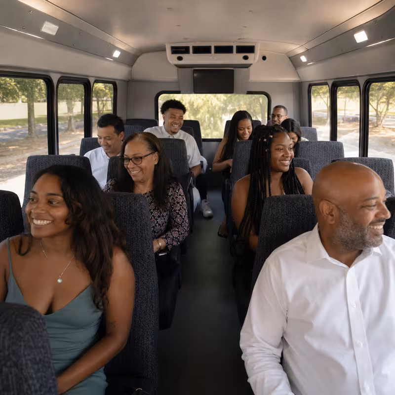 Group boarding a white charter bus for Private Event Transportation transportation in New Brunswick