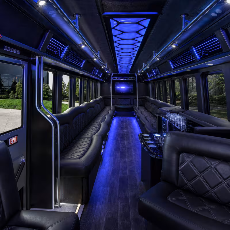 Party bus interior with wraparound leather seating and LED lighting in New Brunswick