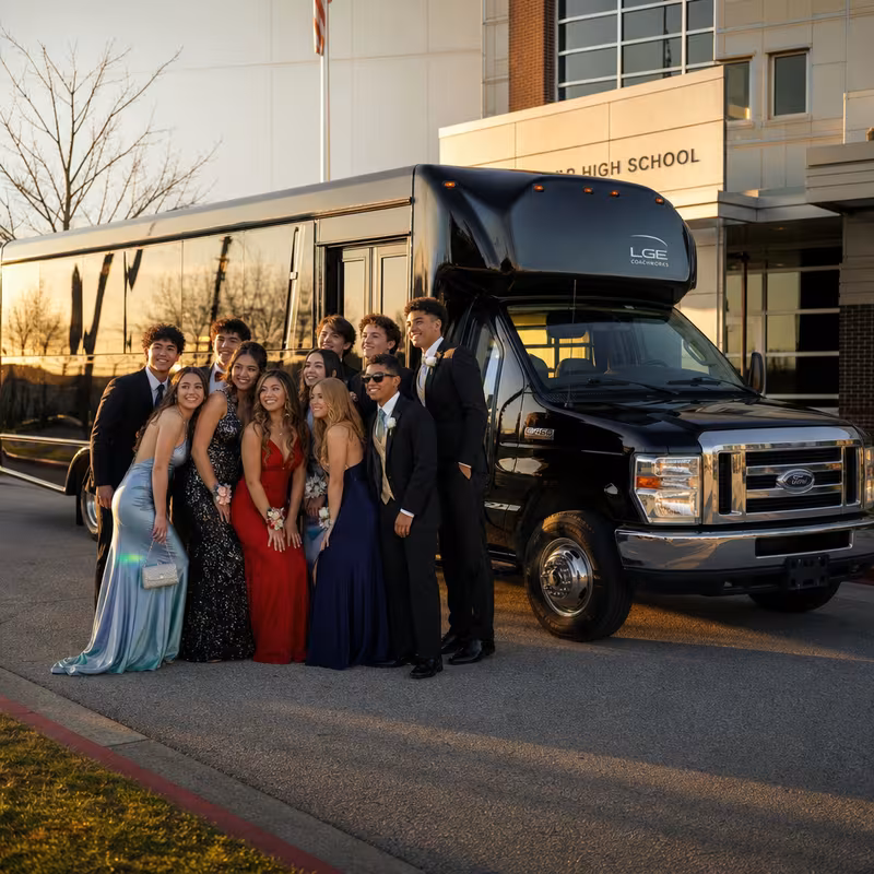 Group boarding a white charter bus for Prom & Homecoming Transportation transportation in New Brunswick