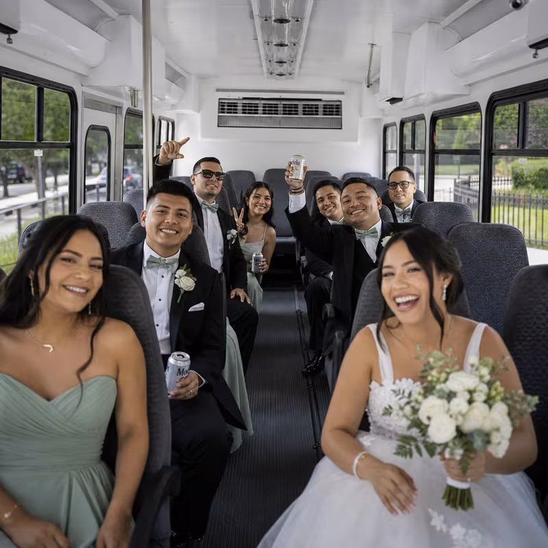 Group boarding a white charter bus for Wedding Transportation transportation in New Brunswick